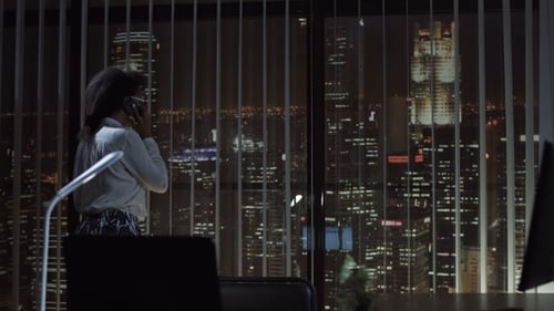 Smiling Woman Talking Phone in Office