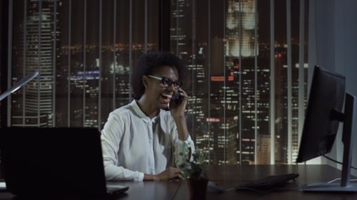 Smiling Woman Talking Phone in Office