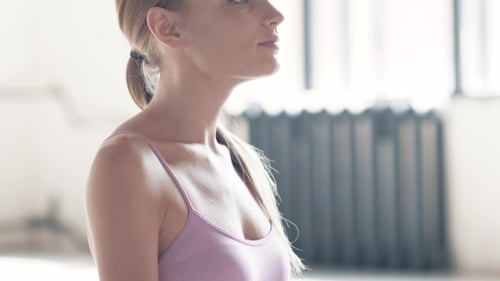 Woman Meditating in Yoga Pose Indoors