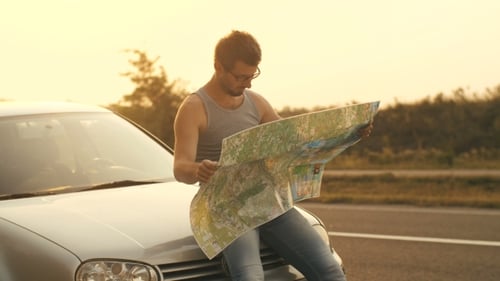 Traveling By Car Man Looking at the Map