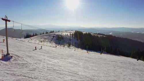 Old Ski Station on a Snowy Mountain Slope with a Lot of People on Skis and Snowboards