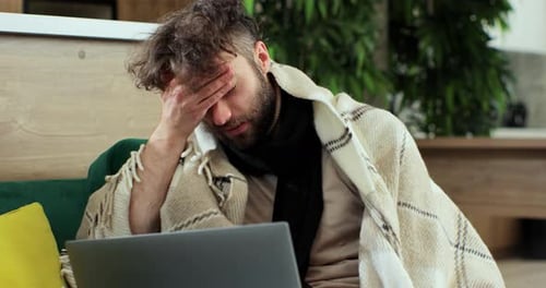 Ill Man Working on Laptop at Home