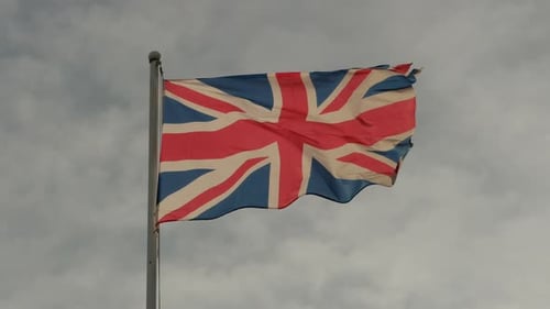 Tattered United Kingdom Flag Blowing Gently in the Breeze