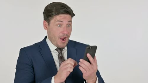Man in Suit Celebrates News on Phone