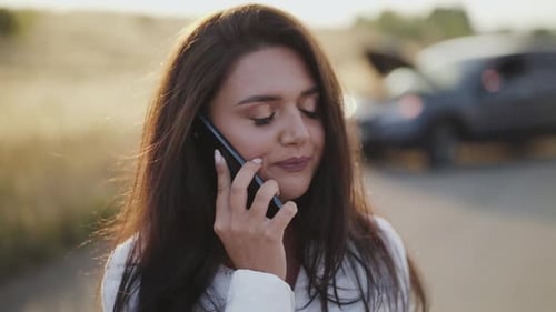 Woman Talking on Cellphone on Rural Road