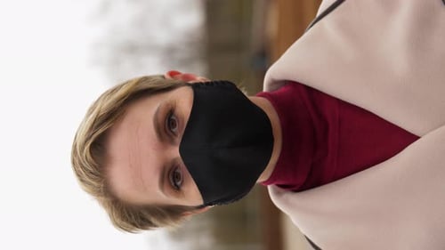 Blonde Woman Wearing Mask in City Portrait