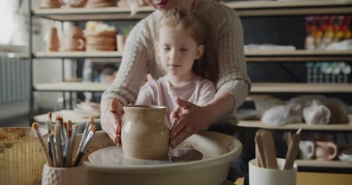 Woman and Child Creating Pottery Together