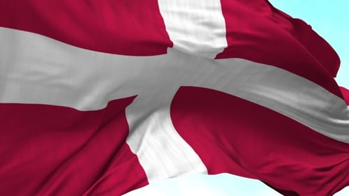 Waving Fabric Flag of Denmark Against Blue Sky