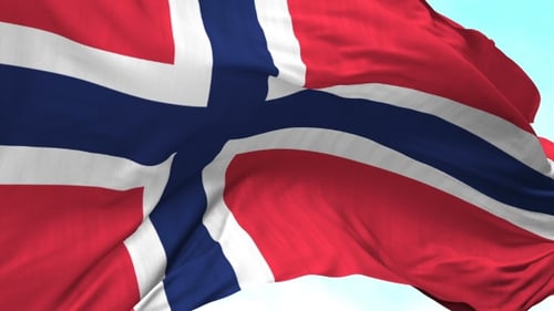 Waving Norway Flag Against Blue Sky Background