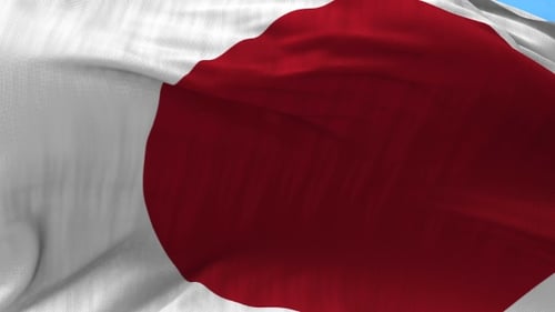 Realistic Waving Japan Flag Against a Bright Blue Sky