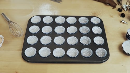 Stop Motion. Paper Cups, Wrappers for Cupcakes Putting Into the Baking Tray for Muffins Cooking in