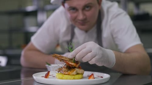 Chef Plating Delicious Shrimp Dish in Restaurant Kitchen