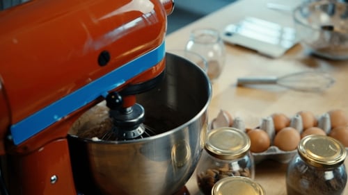 View of Working Red Mixer Standing at the Table in the Kitchen Whisk Preparing the Dough for