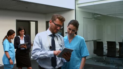 Medical Professionals Collaborating Using Tablet Technology