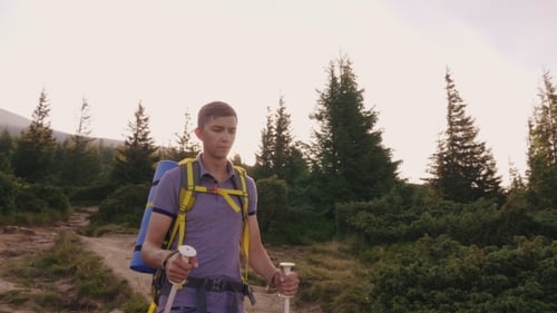 A Young Man Climbs a Mountain