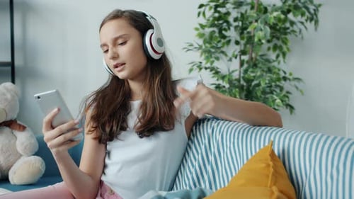 Teenage Girl Listening Music at Home