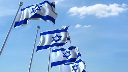 Waving Israeli Flags Against a Blue Sky