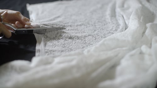 Cutting White Lace Fabric with Scissors at Home