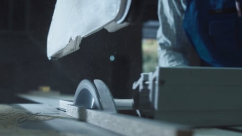 Worker Cutting Detail in Shop
