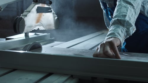 Man Cutting Detail in Workshop