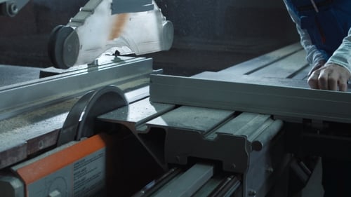 Worker Cutting Detail in Shop