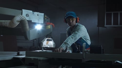Man Working with Saw in Shop