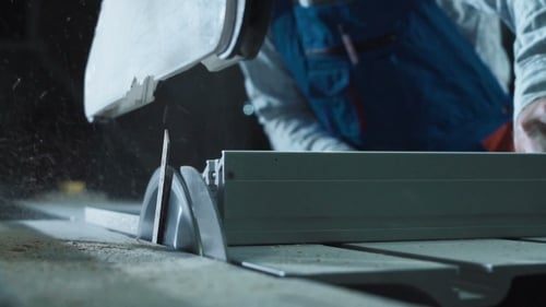 Worker Cutting Detail in Shop
