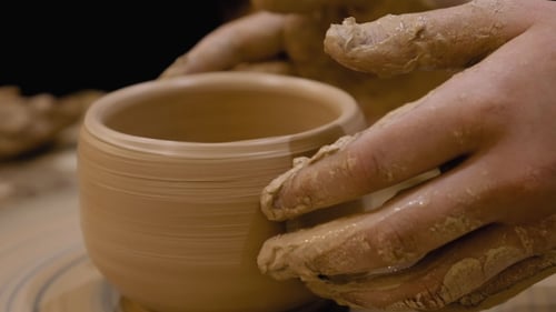 Potter Shaping Clay Bowl on Wheel