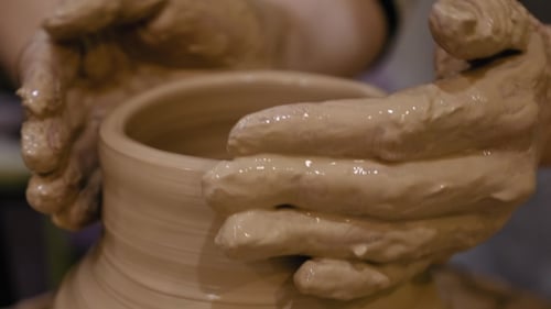 Hands Shaping Clay on a Pottery Wheel