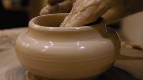 Close Up of Hands Shaping Clay Pot