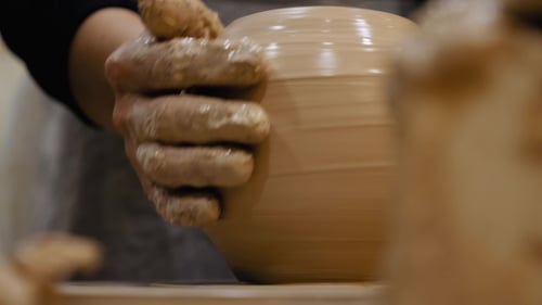 Hands Shaping Clay on Pottery Wheel