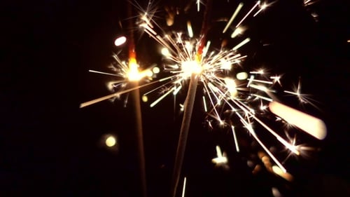 Burning Sparklers Shooting off Bright Sparks at Night