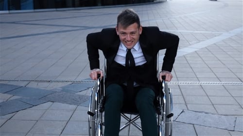 Capable Cripple Man Trying To Get Up From the Wheelchair