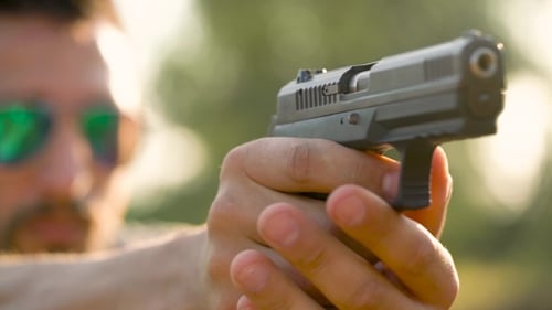 Young Man Is Shooting From a Gun