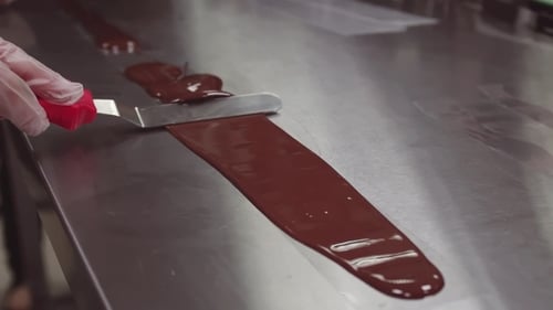 Spreading Melted Chocolate with a Spatula on Metal