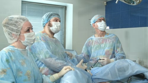 Team of Doctors Working Together During a Surgery in an Operating Room at a Hospital