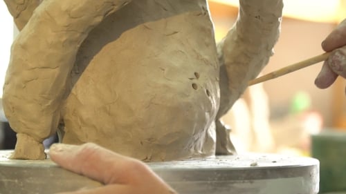 Artist Working with Clay to Form Sculpture