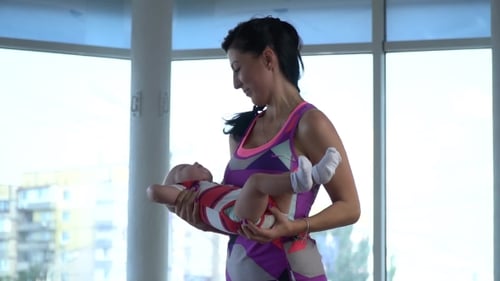 Mom Pulls on Arms Child and He Pulls the Little Legs in His Socks