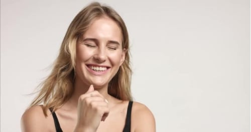Smiling Woman in Close Up on Light Background