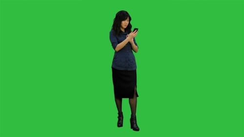 Asian Businesswoman Using Mobile Phone on a Green Screen, Chroma Key