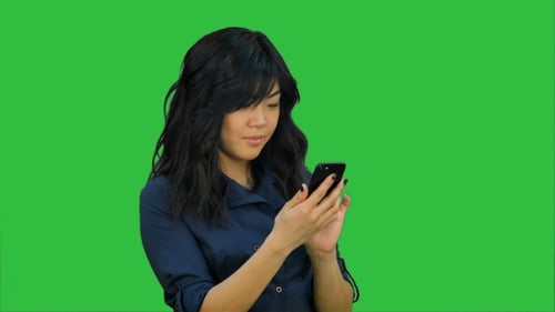 Businesswoman Using of Mobile Phone on a Green Screen, Chroma Key