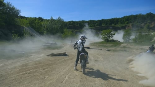Motocross Rider on Dirt Bike in Rural Landscape