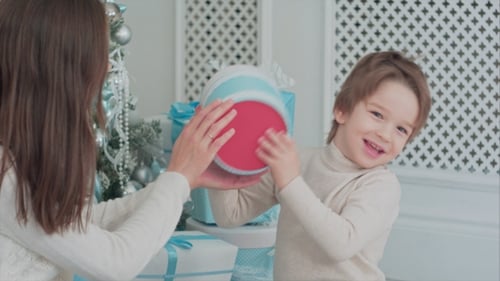 Boy Receives Christmas Gift From Female Family Member