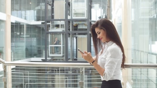 Businesswoman Using Tablet in Office Building