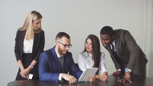 Team Using Tablet in Workplace Office Setting