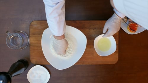 Chef Breaking Eggs for Cooking Preparation