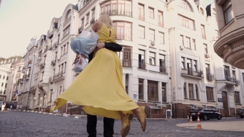 Couple Embracing in European City Street