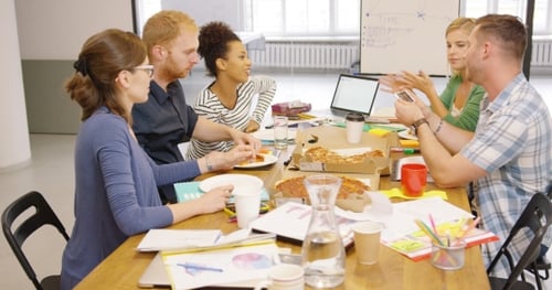 Colleagues Eating Pizza at Office Table