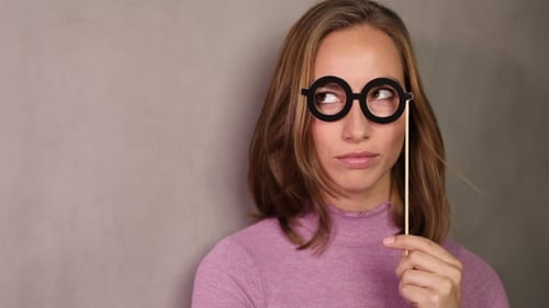 Smiling Woman Posing with Novelty Glasses