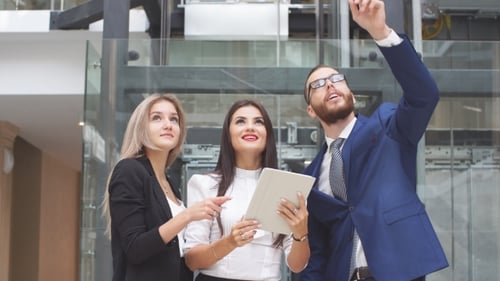 Business Team Collaborating With Tablet Indoors